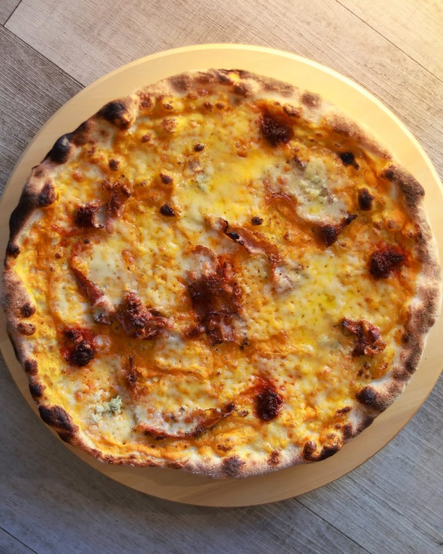 Classic pizza on the board at Pizzeria La Lupa